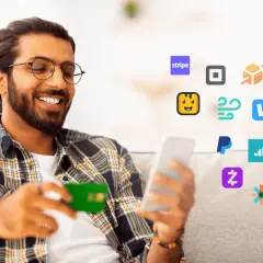 Smiling man with a credit card and phone surrounded by payment app icons, including Stripe, PayPal, and others, suggesting easy transactions and managing cheddar up fees.