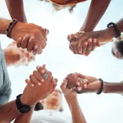 Hands clasped in unity, a circle of support. Ready to give, send, and go forward together.