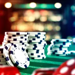 Stacks of casino chips on a green felt table, ready for a casino fundraiser.