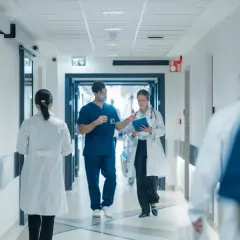 Doctors walk down a hospital hallway. The question of whether hospital board members get paid is a complex one, often debated.
