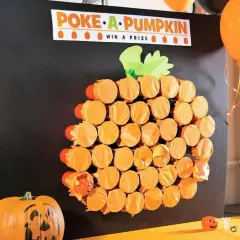 Poke-a-Pumpkin" game board, a fun fall festival idea for adults. Orange cups form a pumpkin shape, hiding prizes.