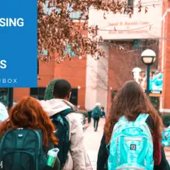 Students walk on campus with backpacks. The image features "Fundraising Ideas for Colleges" and @Donorbox, suggesting creative ways to support educational institutions.