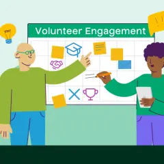 Two people are communicating with volunteers, planning activities on a whiteboard with icons for graduation, handshake, and awards.