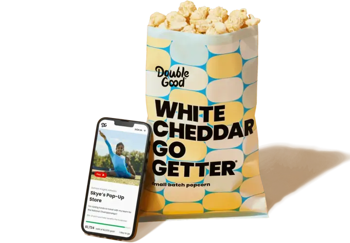 A bag of Double Good White Cheddar popcorn and a smartphone displaying a virtual fundraiser for Skye's Pop-Up Store, showcasing how virtual fundraisers like Double Good support teams.
