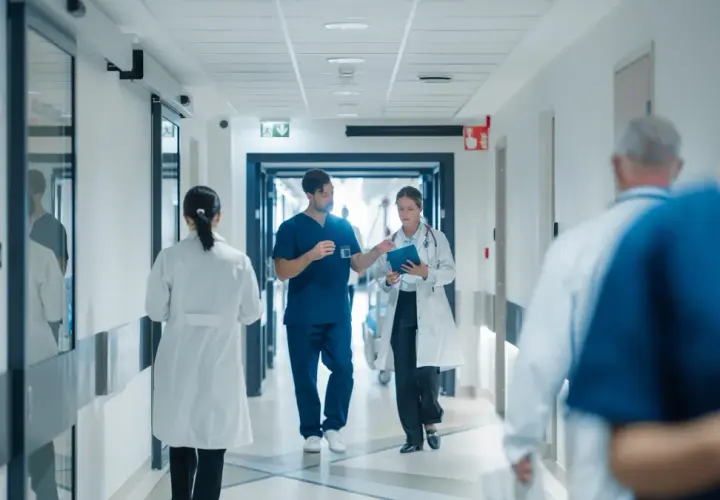 Doctors walk down a hospital hallway. The question of whether hospital board members get paid is a complex one, often debated.