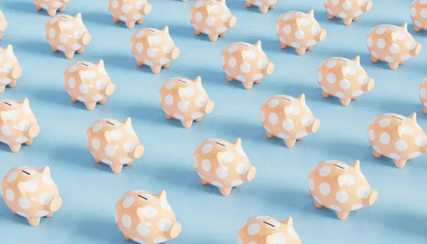 Rows of peach piggy banks with white polka dots on a light blue background. A fun visual for a 50/50 cash raffle.