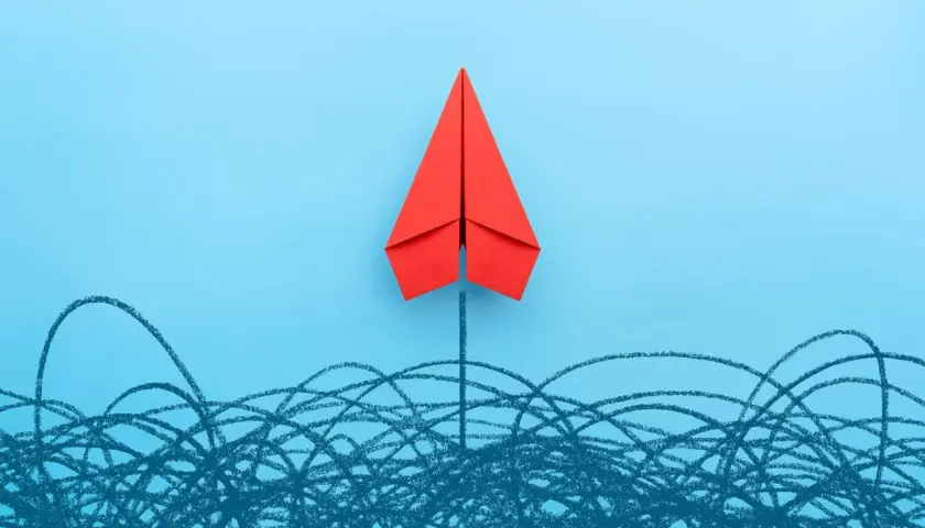 A red paper airplane soars above a chaotic scribble, symbolizing a new board of directors breaking through challenges.