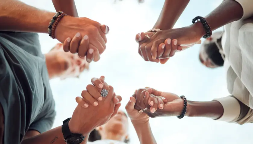 Hands clasped in unity, a circle of support. Ready to give, send, and go forward together.