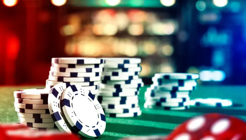 Stacks of casino chips on a green felt table, ready for a casino fundraiser.
