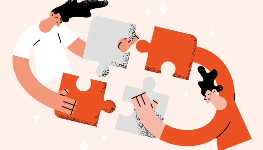 Two people assemble puzzle pieces, symbolizing the collaborative effort needed for a successful annual fund plan.