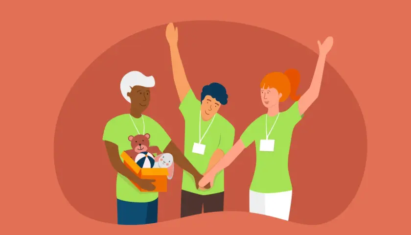 Three diverse volunteers in green shirts with lanyards, one holding a box of toys, show how to get volunteers for a nonprofit.