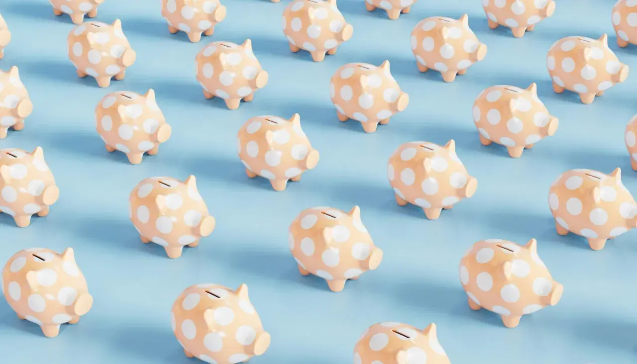 Rows of peach piggy banks with white polka dots on a light blue background. A fun visual for a 50/50 cash raffle.
