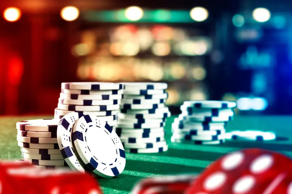Stacks of casino chips on a green felt table, ready for a casino fundraiser.