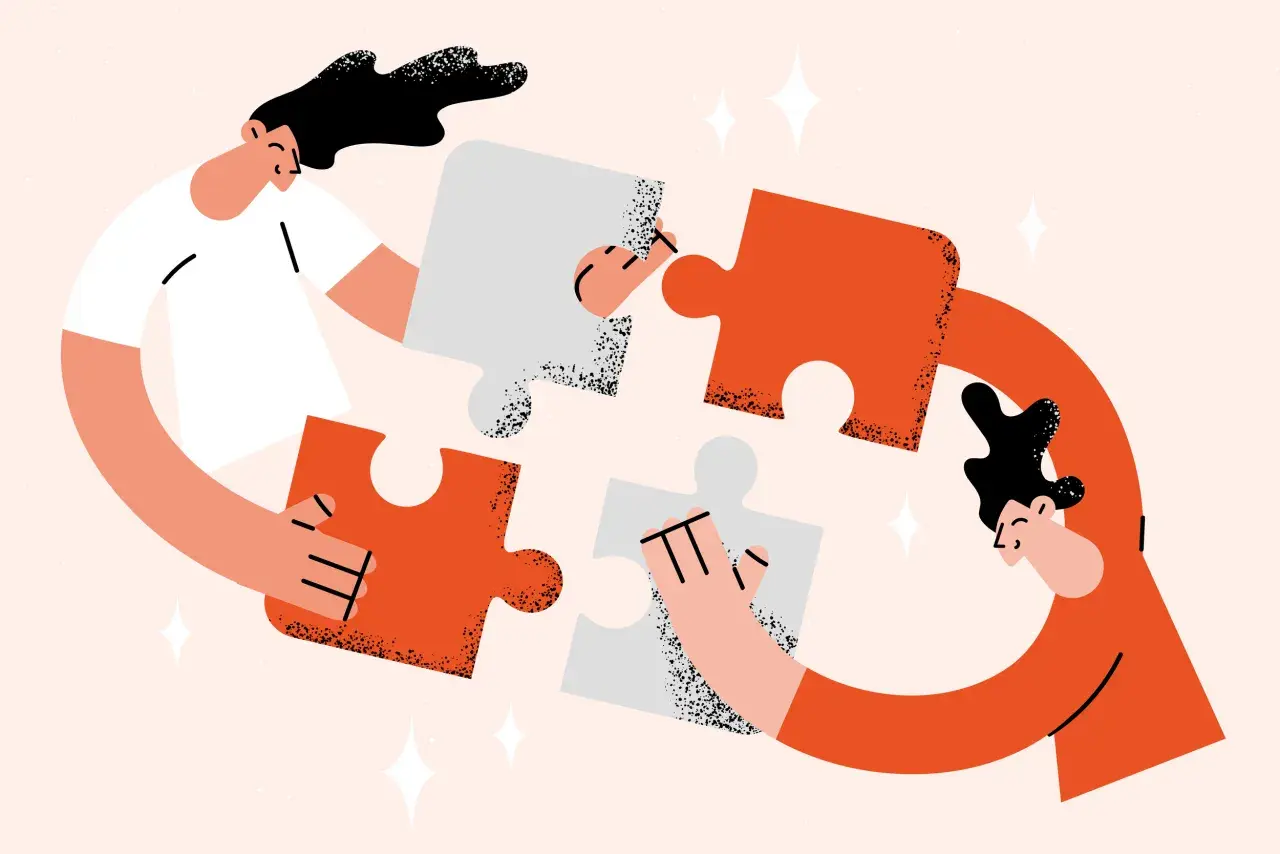 Two people assemble puzzle pieces, symbolizing the collaborative effort needed for a successful annual fund plan.