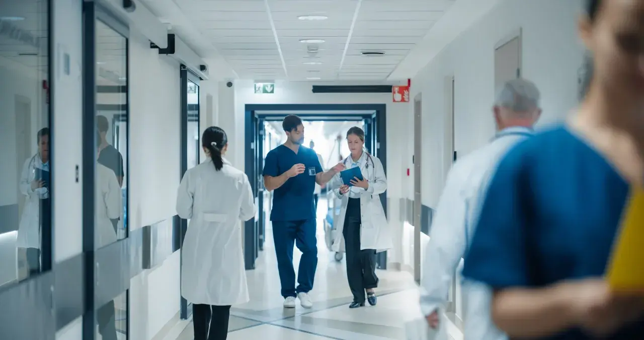 Doctors walk down a hospital hallway. The question of whether hospital board members get paid is a complex one, often debated.