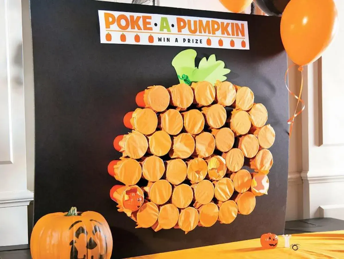 Poke-a-Pumpkin" game board, a fun fall festival idea for adults. Orange cups form a pumpkin shape, hiding prizes.