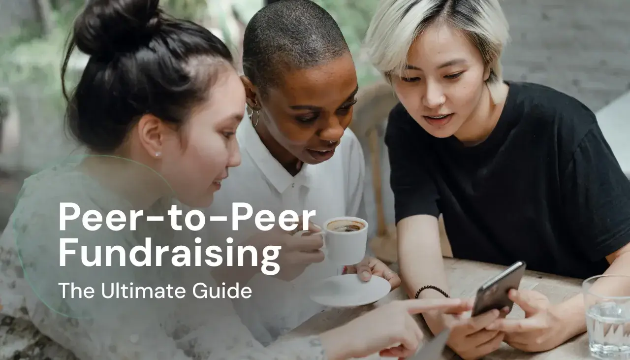 Three friends discuss peer-to-peer fundraising over coffee, looking at a smartphone.