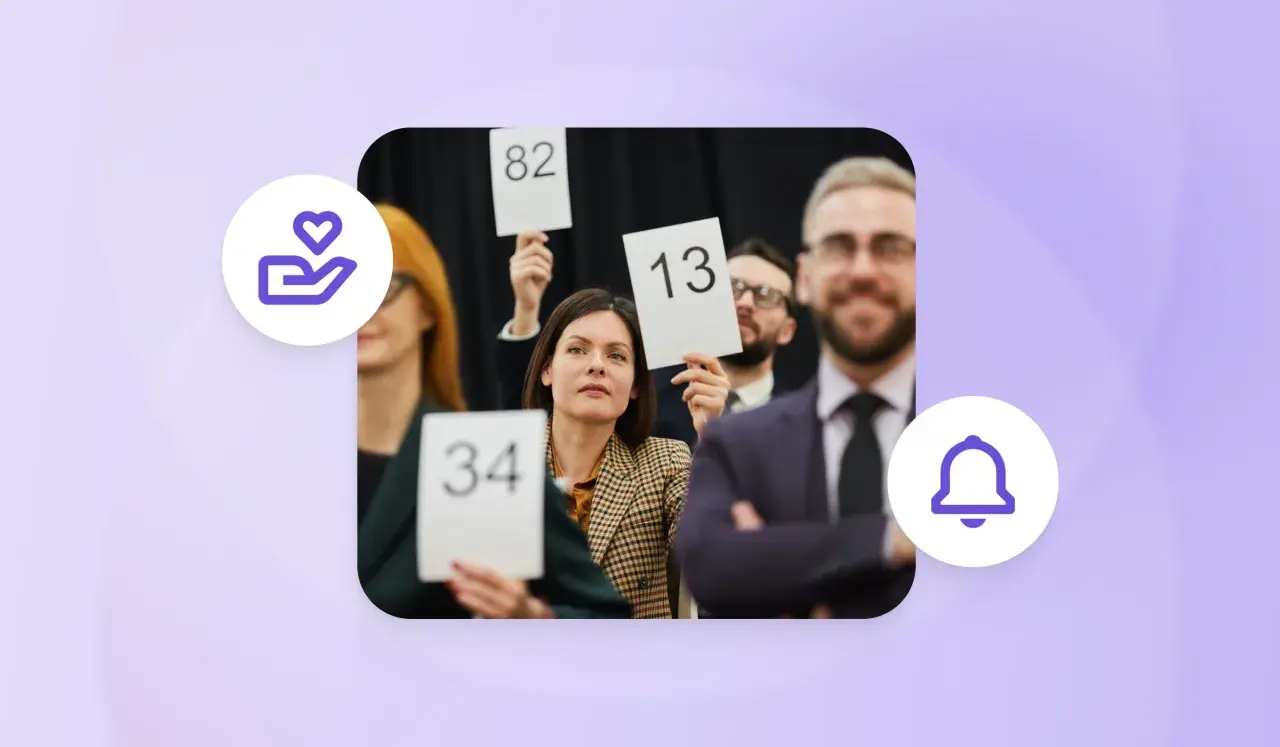 People at an auction, holding up bid numbers like 34, 82, and 13, participating in a paddle raise.