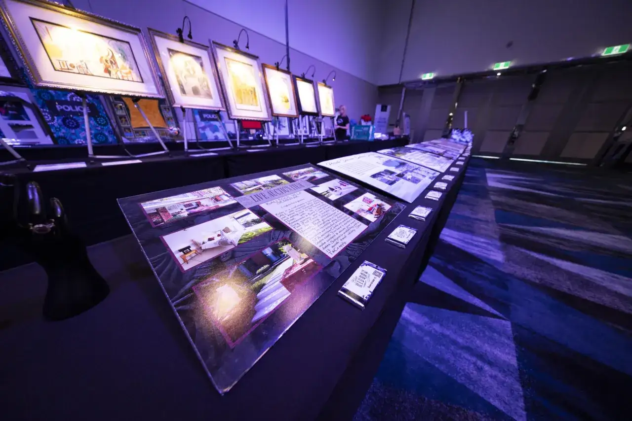 silent auction table display with bid sheets and mobile bidding checkout