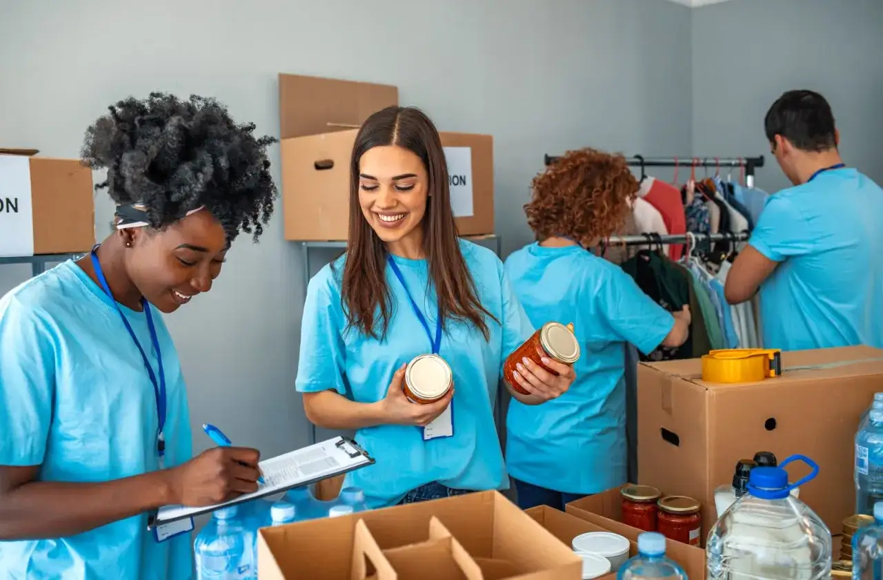 Volunteers organize donations, a key part of fundraising ideas for homeless shelters. They sort food and clothing, preparing for distribution.