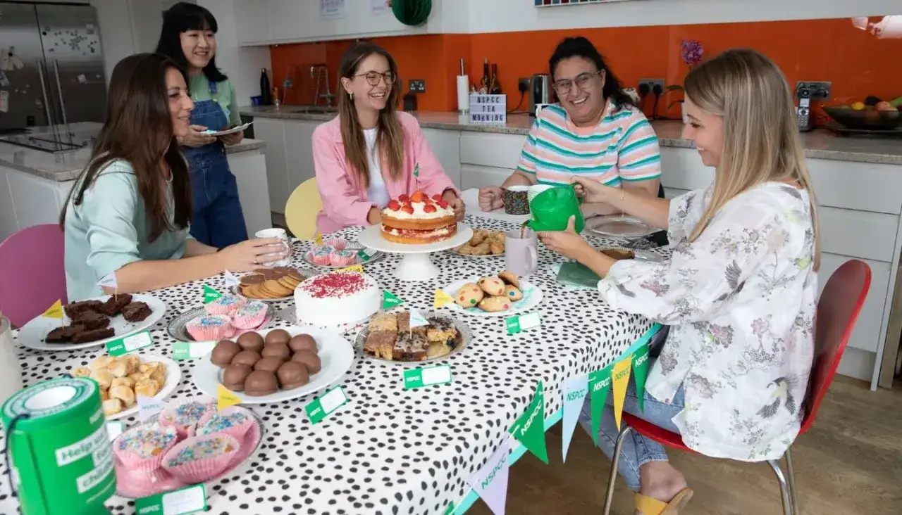 Friends enjoy a tea morning with cakes and cookies, a perfect example of easy fundraisers.