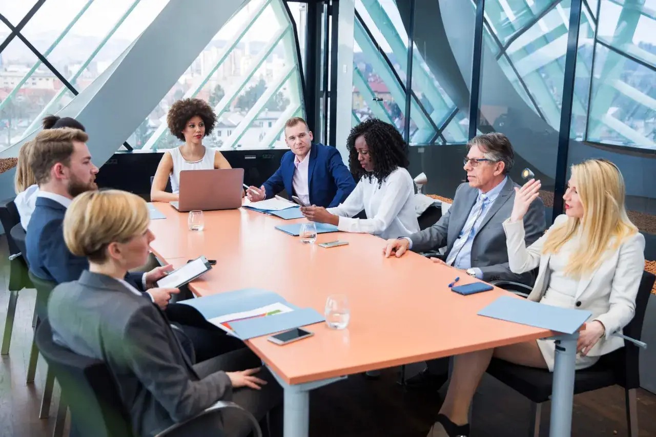 A diverse group of professionals in a modern conference room, discussing a board meeting agenda.