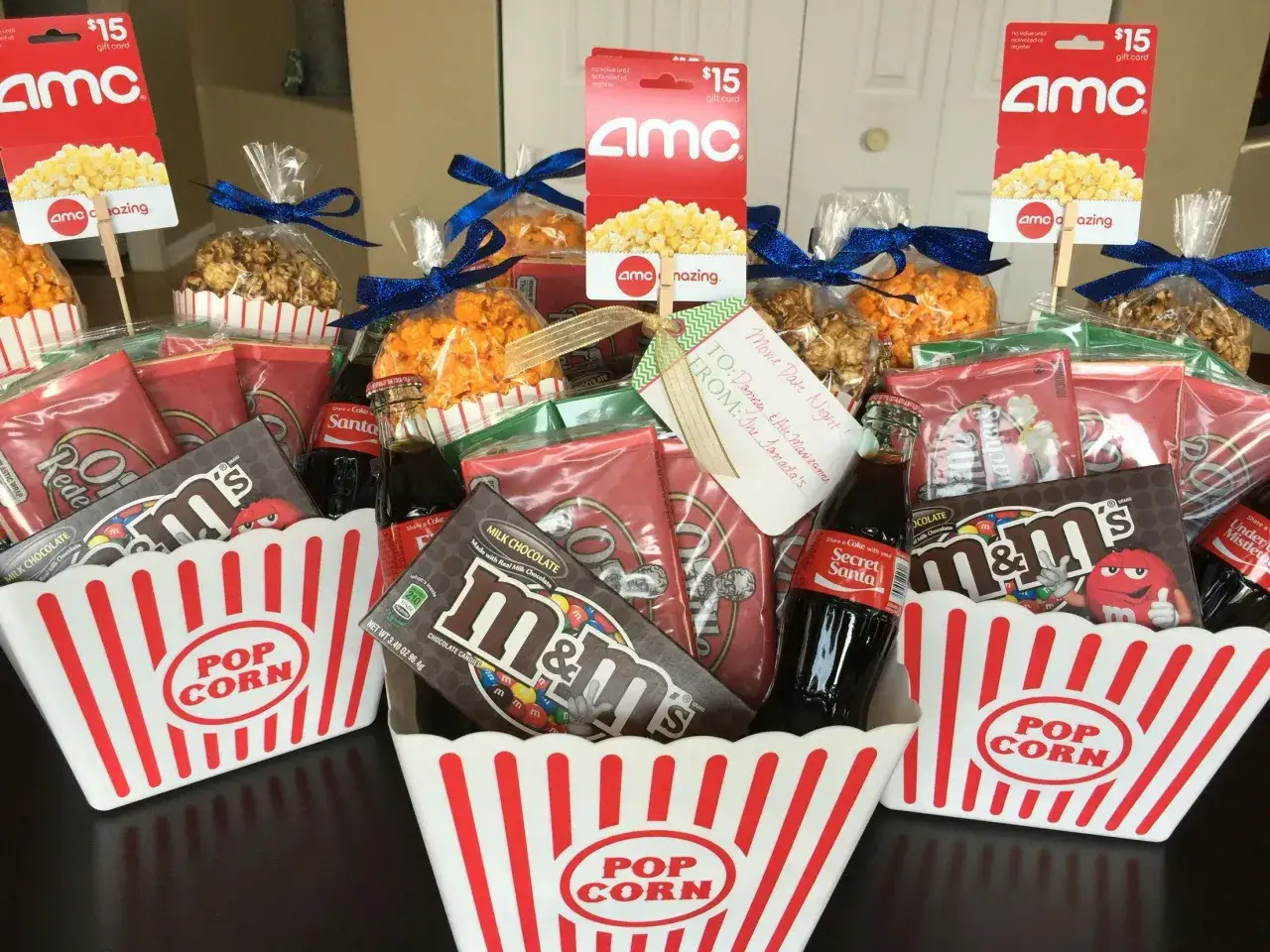 Movie night baskets with popcorn, candy, soda, and AMC gift cards are great cheap raffle prize ideas.