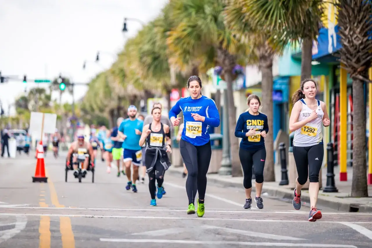 Runners race in a 5k fundraiser. Planning how to organize a 5k fundraiser involves many steps, but seeing participants like these makes it worthwhile.