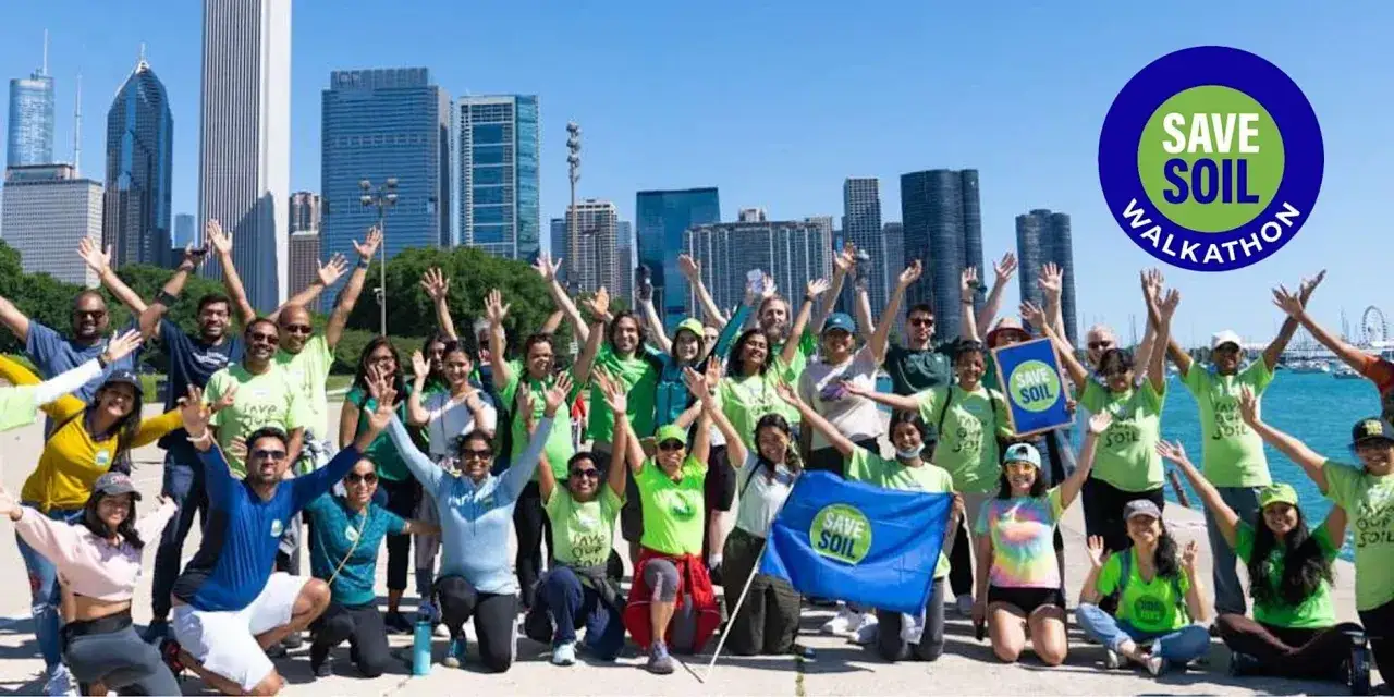 A diverse group of people with their hands raised in celebration at a 