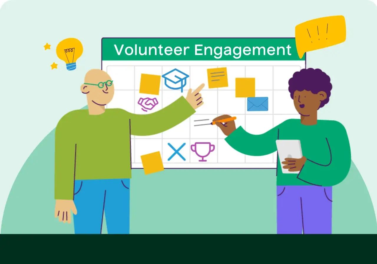 Two people plan volunteer engagement activities on a whiteboard. One points to a graduation cap icon, the other writes.