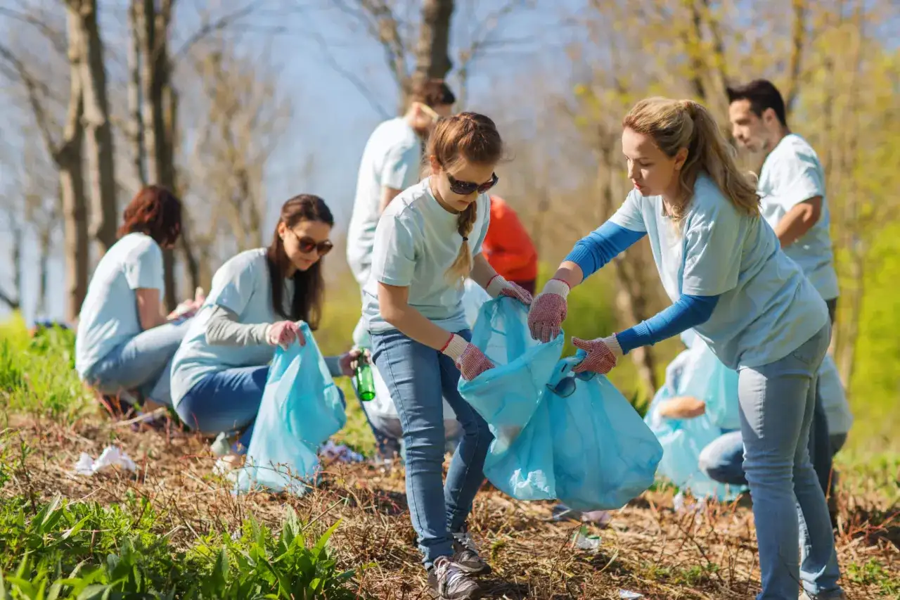 Volunteers collect trash in a park, a great example of successful fundraising ideas through community action.